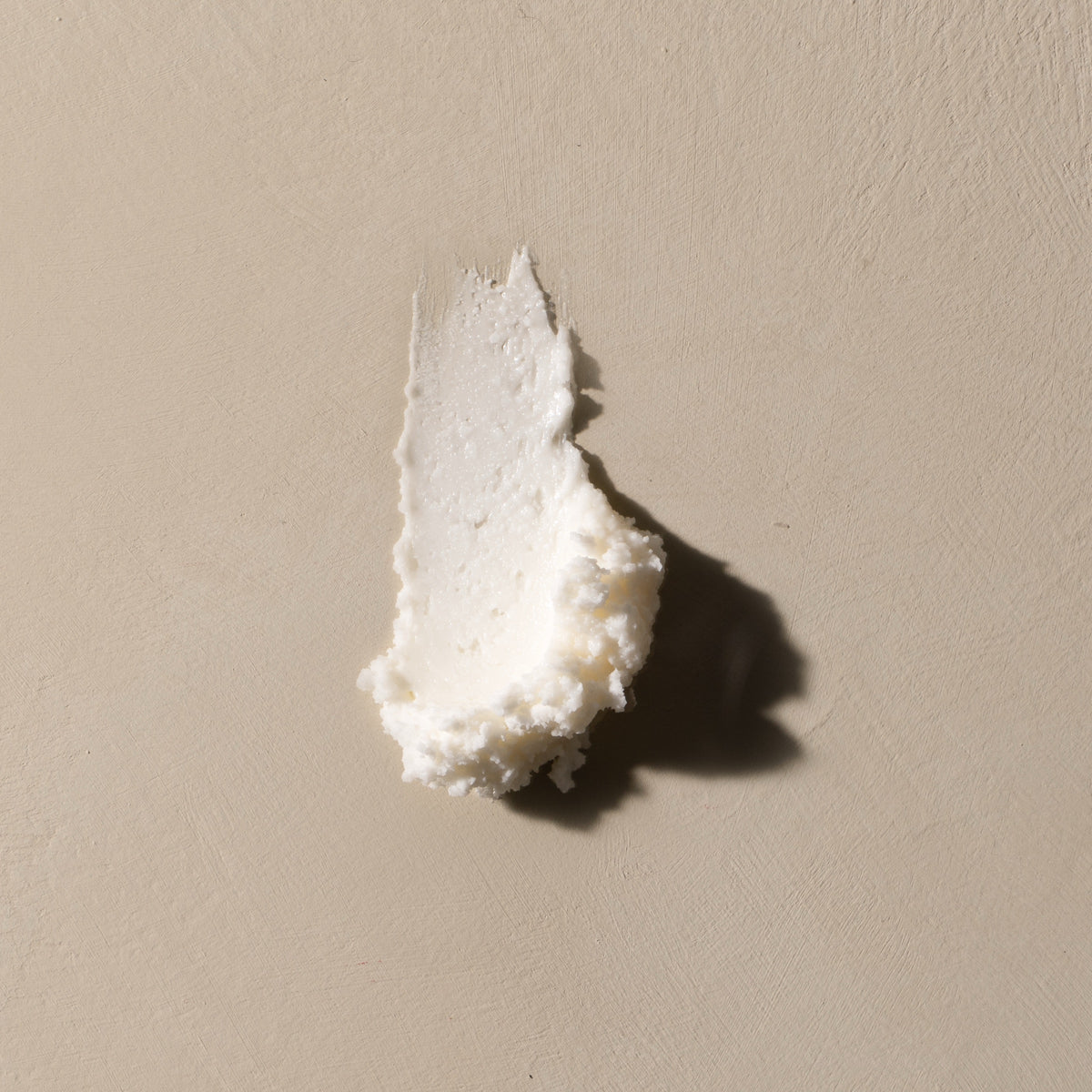 Whipped Breathe Deep balm swiped on a warm stone ground