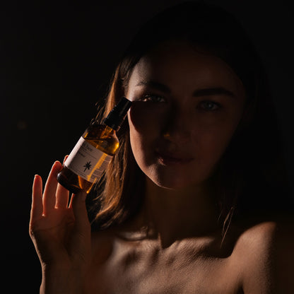 Deep Hydration Mist held to the face, lit low and warm