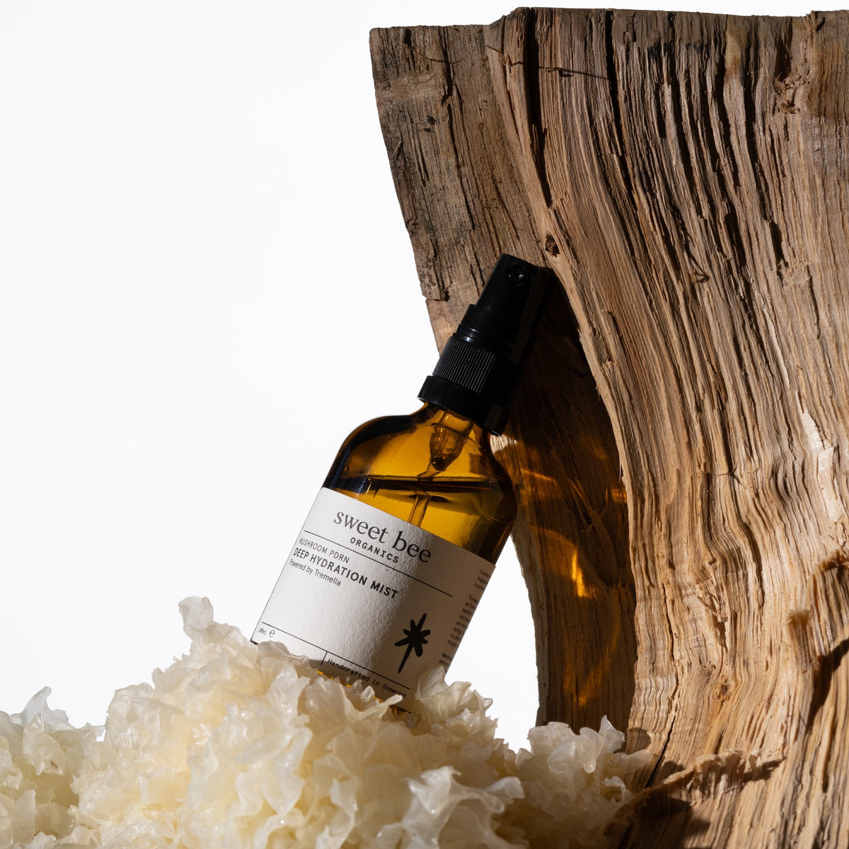 Deep Hydration Mist resting on driftwood with tremella mushroom
