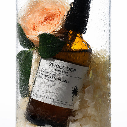 Deep Hydration Mist with a rose and tremella behind water-beaded glass